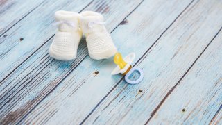 Baby booties on a wooden table