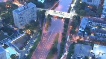 An aerial view shows the Schuylkill River overflowing onto lanes on Interstate 676 in Philadelphia on Thursday, Sept. 2, 2021.