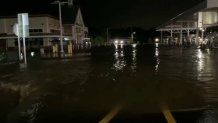 Floodwaters rise around a gas station store and the gas station pumps in Collegeville, Pennsylvania, on Wednesday, Sept. 1, 2021.
