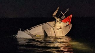 Part of a sunken boat sticks out of the water after a crash in New Jersey.
