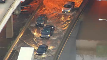 Cars can be seen driving through water on a highway in Philadelphia, Pennsylvania, on Sept. 2, 2021.