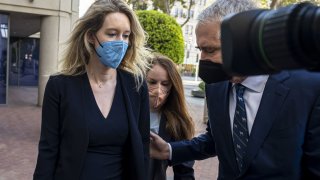 Elizabeth Holmes, founder of Theranos Inc., left, arrives at federal court in San Jose, California, on Tuesday, Aug. 31, 2021.