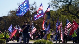 people attend a rally in support of President Donald Trump outside Thousand Oaks City Hall in Thousand Oaks, Calif.