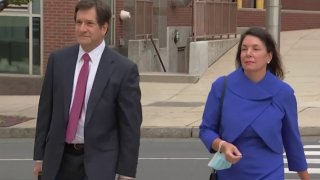 Kathleen McGuiness walks with her attorney