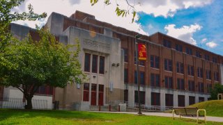 Central High School's front entrance. The three-story building rises in front of a lawn.