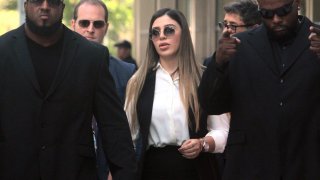 Emma Coronel Aispuro, 31, wife of the notorious drug lord El Chapo, leaves Brooklyn Federal Court surrounded by body guards after her husband was sentenced to life plus 30 years in New York on Wednesday, July 17, 2019.