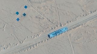 This satellite image shows a building on rail tracks in Ruoqiang county, China