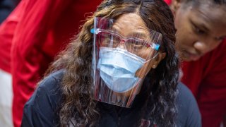 C. Vivian Stringer of the Rutgers Scarlet Knights in a mask and face shield