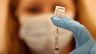 Woman with needle and vaccine