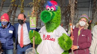Phillie Phanatic stands with a group of people