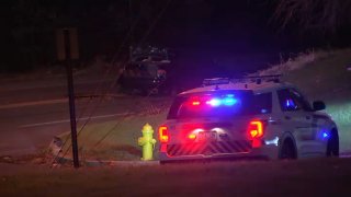 A police SUV with its lights on parks near a curb after a hit-and-run crash in Allentown, Pennsylvania.