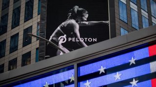 A monitor displays Peloton Interactive Inc. signage during the company’s initial public offering (IPO) across from the Nasdaq MarketSite in New York, U.S., on Thursday, Sept. 26, 2019.