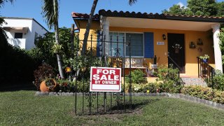 A For Sale sign is seen in front of a home in Miami, Florida.