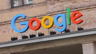 The Google corporate logo hangs outside one of its offices on August 31, 2021.