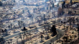 A view of a Boulder County neighborhood that was destroyed by a wildfire is seen from a Colorado National Guard helicopter during a flyover by Gov. Jared Polis on Friday, Dec. 31, 2021. Tens of thousands of Coloradans driven from their neighborhoods by a wind-whipped wildfire anxiously waited to learn what was left standing of their lives Friday as authorities reported more than 500 homes were feared destroyed.