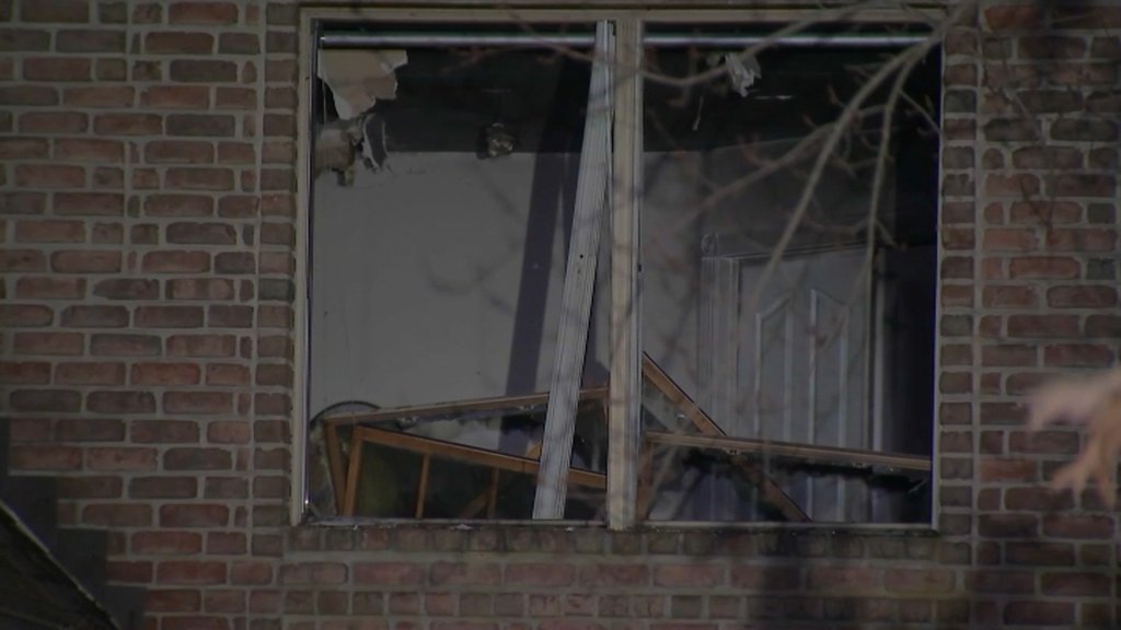A broken window of Tyrese Maxey's New Jersey home after a fire