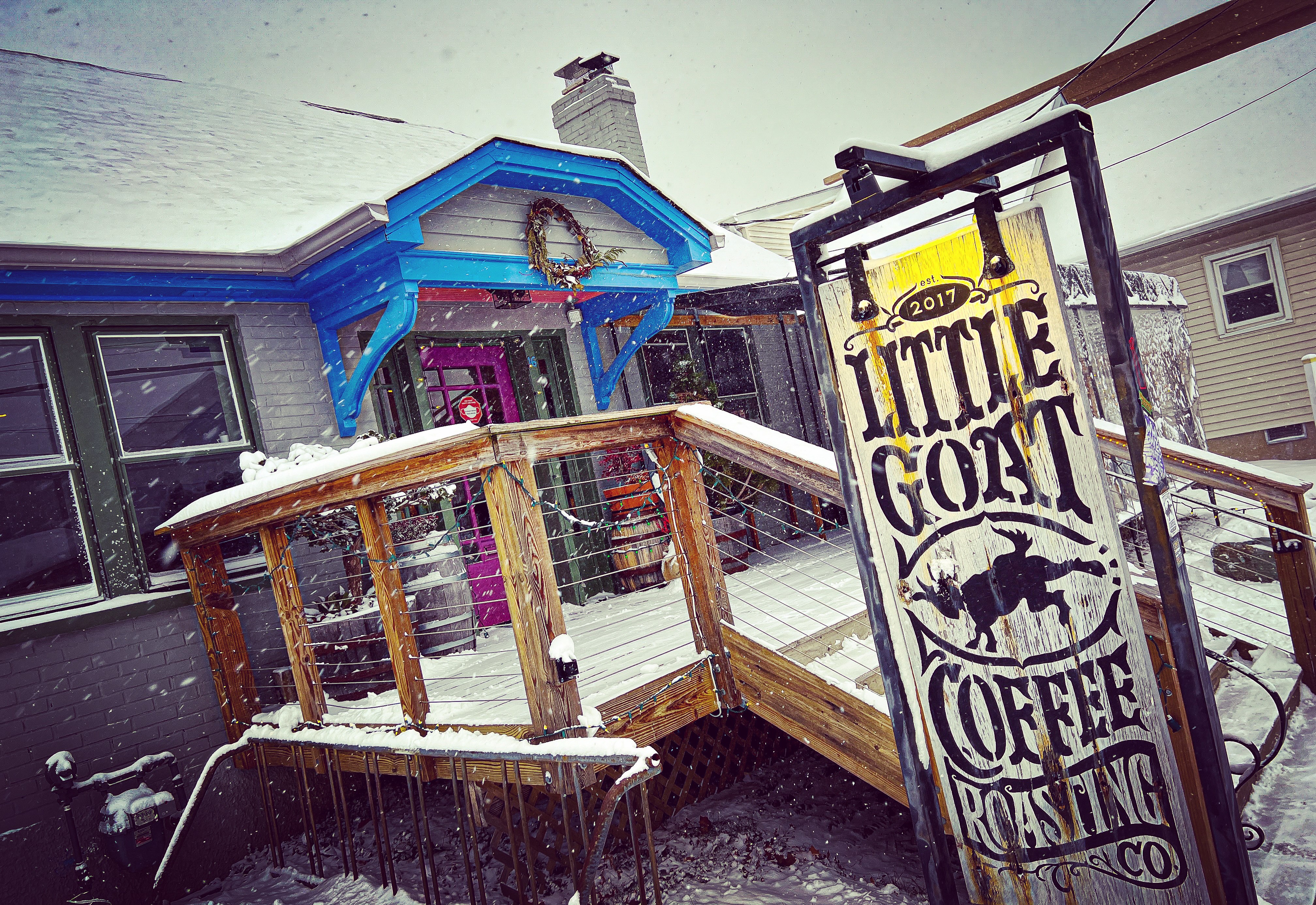 Snow falls on the deck of a coffee shop in Newark, Del.