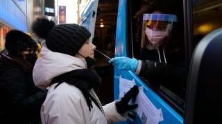 People get tested at a mobile Covid-19 testing van in Times Square on January 4, 2022, in New York City.