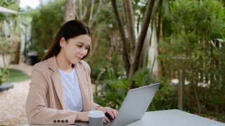 Asian woman working laptop. Business woman busy working on laptop computer at cafe.