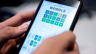 This photo illustration shows a person playing online word game “Wordle” on a mobile phone in Washington, DC on January 11, 2022.