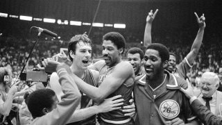 Philadelphia 76ers Bobby Jones, left, embraces Julius Erving after the 76ers defeated the Los Angeles Lakers in four straight games to win the NBA Championship, May 31, 1983.