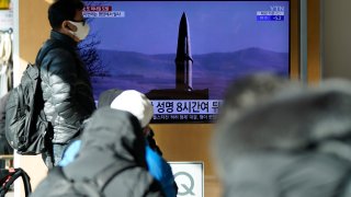 People watch a TV screen showing a news program reporting about North Korea’s missile launch with a file image, at a train station in Seoul, South Korea, Monday, Jan. 17, 2022.