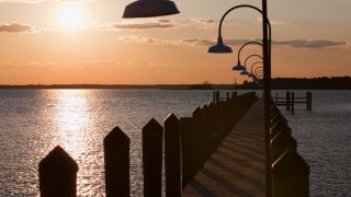 Winter sunset at a fishing pier in Dewey Beach, overlooking Rehoboth Bay, Delaware.