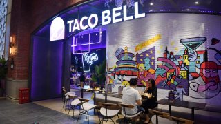 People eat at a newly-opened Taco Bell restaurant in Beijing on August 21, 2020.