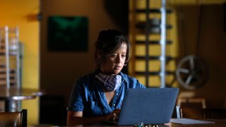 SAN FRANCISCO, CA – APRIL 28: Deanna Sison takes a break from preparing preordered lunches to check the status of her federal small business loan application at Little Skillet restaurant in San Francisco, Calif. on Tuesday, April 28, 2020. Most Covid financial relief to small business has now ended, but the need for more funding remains.