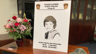 A poster of Marise Ann Chiverella is displayed with a vase of flowers and a trooper’s hat at a Pennsylvania State Police news conference in Hazleton, Pa., Thursday, Feb. 10, 2022.