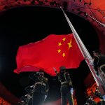 The Chinese national flag is raised during the opening ceremony of the 2022 Winter Olympics, Friday, Feb. 4, 2022, in Beijing.