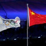The Chinese and Olympic flags fly during the opening ceremony of the 2022 Winter Olympics, Friday, Feb. 4, 2022, in Beijing.