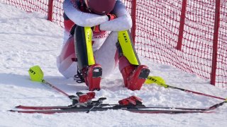 Mikaela Shiffrin, of the United States sits on the side of the course after skiing out in the first run of the Women's Slalom at the 2022 Winter Olympics, Wednesday, Feb. 9, 2022, in the Yanqing district of Beijing, China.