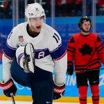 United States' Kenny Agostino (11) celebrates after scoring a goal against Canada during a preliminary round men's hockey game at the 2022 Winter Olympics, Feb. 12, 2022, in Beijing.