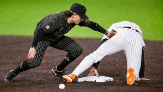 Vanderbilt infielder Carter Young attempts to tag out Nolan McLean at second base