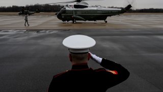 A US Marine salutes as Marine One carrying US President Joe Biden lands at Delaware Air National Guard base in Wilmington, Delaware