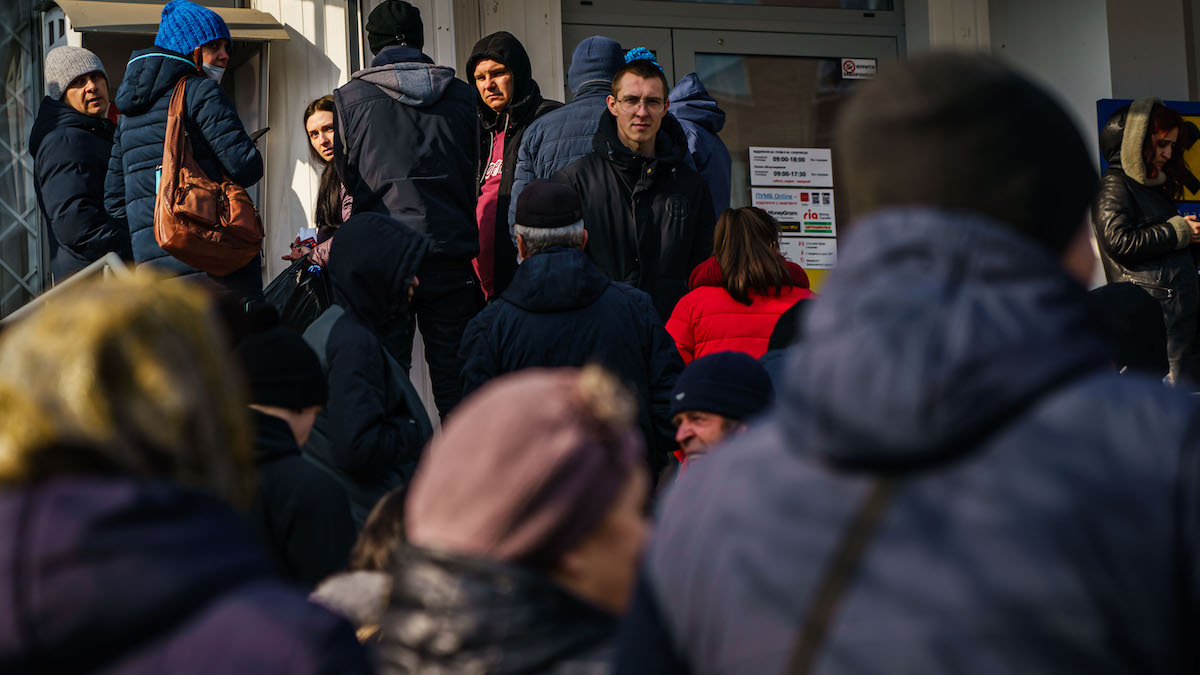 A line for the ATM grows as people try to obtain cash as news of Russia invading Ukraine continues to dominate the headlines,  in Slovyansk, Ukraine, Thursday, Feb. 24, 2022. 