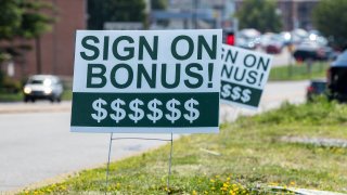 A sign reading “sign on bonus” is seen at a Perkin’s Restaurant which is hiring workers.