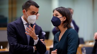 Italian Foreign Minister Luigi Di Maio, left, shares a word with German Foreign Minister Annalena Baerbock at a meeting of the EU foreign ministers at the Europa building in Brussels, Monday, Mar. 21, 2022. European foreign ministers are debating how to respond to Russia's invasion of Ukraine.