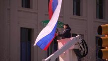 Worker replacing the Russian flag on the Ben Franklin Parkway