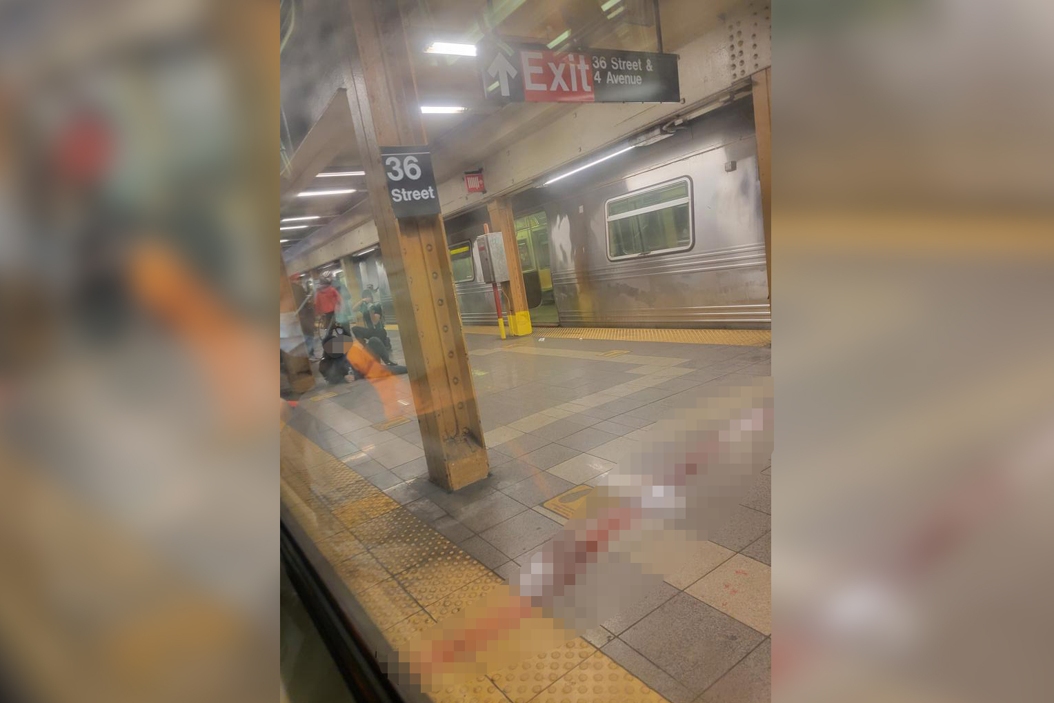 Injured subway riders seen on the platform of the 36th Street station in Brooklyn's Sunset Park neighborhood in New York, April 12, 2022. At least five people have been shot by a man in a gas mask and orange construction vest, according to the NYPD.