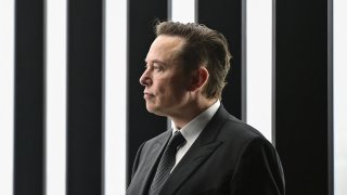 Elon Musk looks to the left of the frame