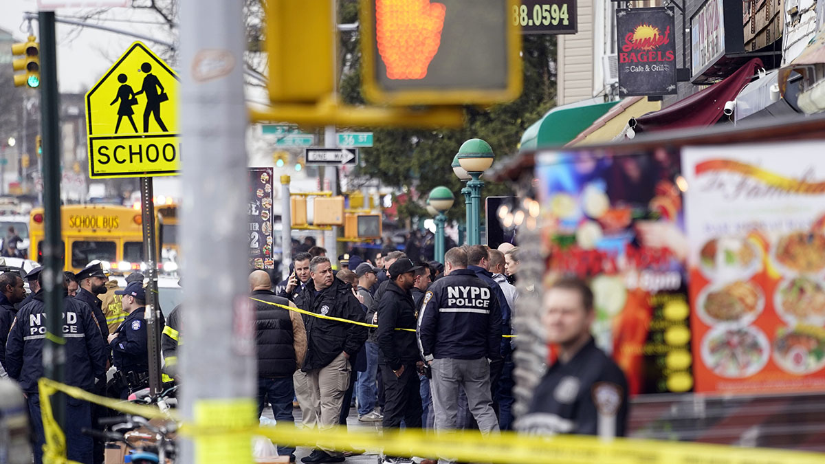 NYPD gather at the entrance to a subway stop in the Sunset Park neighborhood of the Brooklyn borough of New York, April 12, 2022.