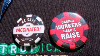 Buttons are pictured on the shirt of a casino worker in Atlantic City, N.J., on April 29, 2022, in support of efforts by their union to obtain a "significant" wage increase in contract talks currently under way.