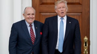 President-elect Donald Trump, right, and former New York Mayor Rudy Giuliani pose for photographs as Giuliani arrives at the Trump National Golf Club Bedminster clubhouse, Sunday, Nov. 20, 2016, in Bedminster, N.J..
