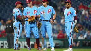 Phillies Jean Segura, Rhys Hoskins, Alec Bohm and Johan Camargo in light blue uniforms during a mound visit