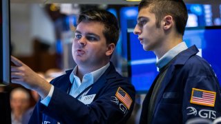 Traders work on the floor of the New York Stock Exchange.
