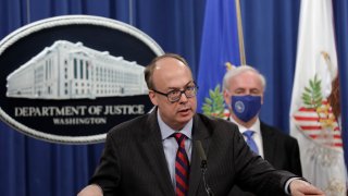 Acting Assistant U.S. Attorney General Jeffrey Clark speaks next to Deputy U.S. Attorney General Jeffrey Rosen at a news conference, where they announced that Purdue Pharma LP has agreed to plead guilty to criminal charges over the handling of its addictive prescription opioid OxyContin at the Justice Department on October 21, 2020 in Washington, DC.