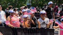 Kids wave American flags while in line for free Wawa hoagies