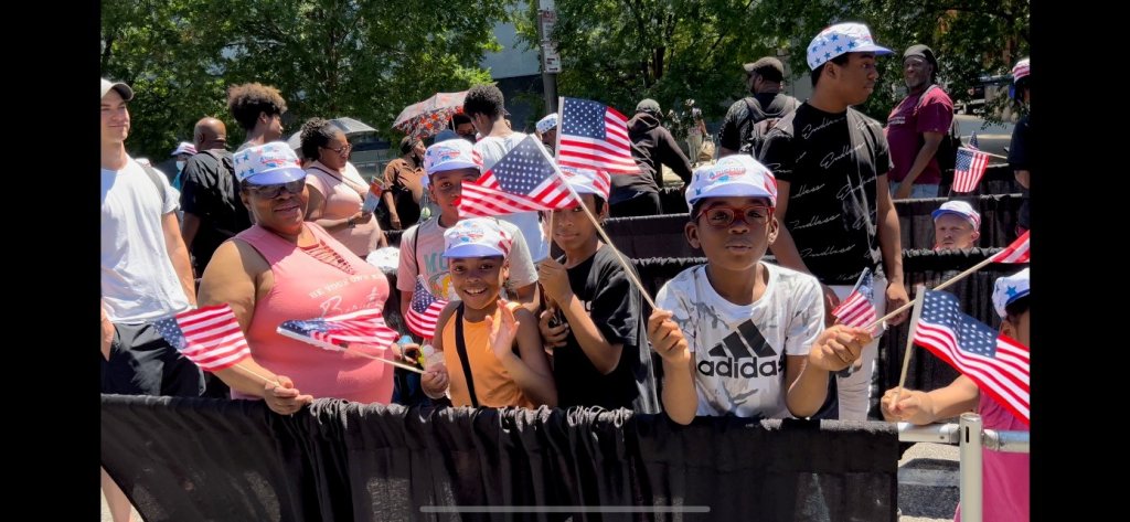 Kids wave American flags while in line for free Wawa hoagies